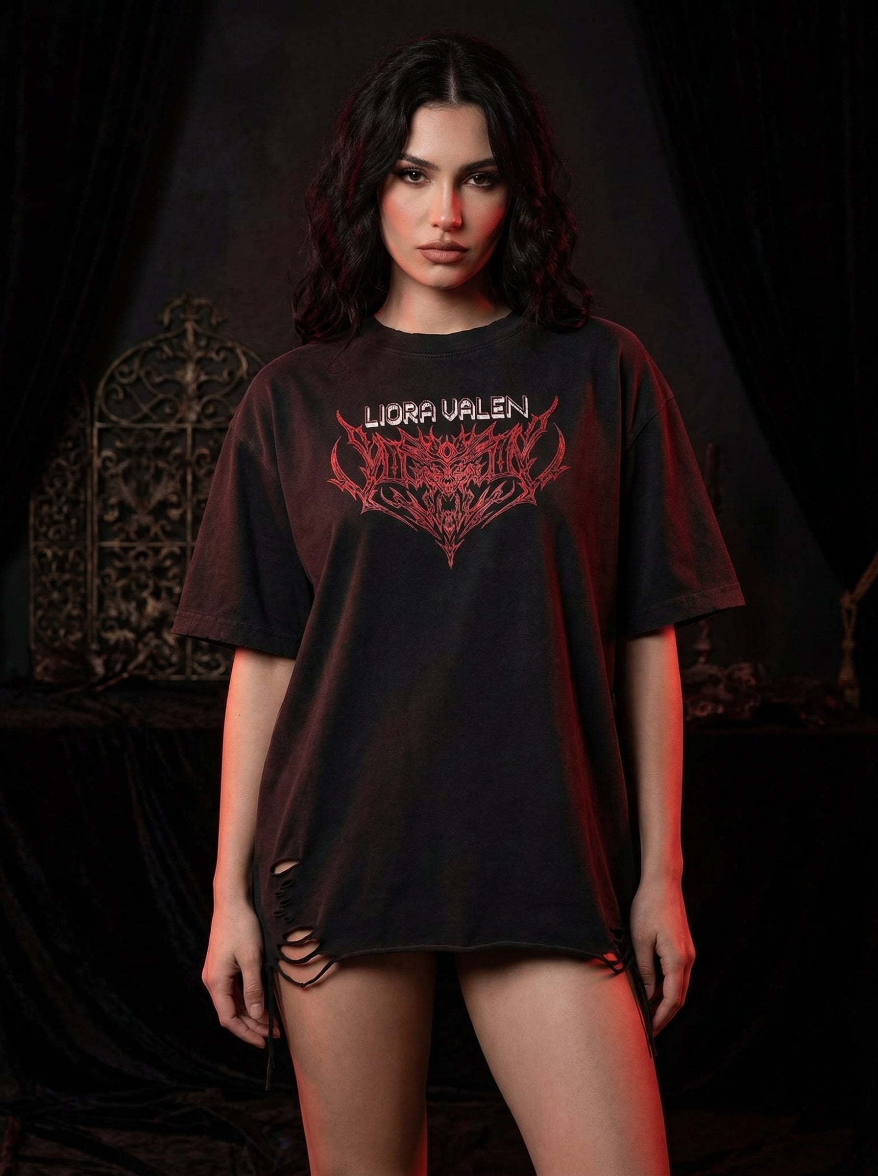 Person wearing a black t-shirt with red and white design against a dark background